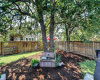 Large treed corner lot loaded with outdoor lighting.