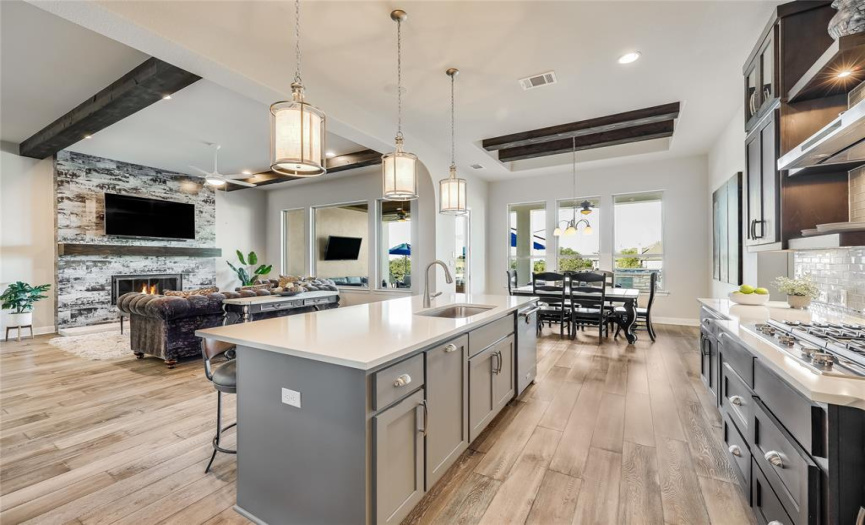 The open design seamlessly connects the kitchen to the living room and breakfast nook.