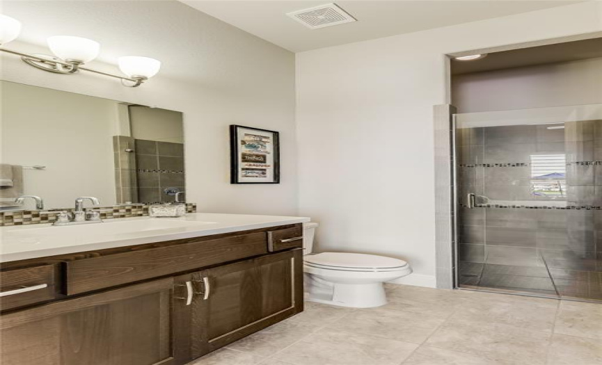 The ensuite bath is complete with a walk-in shower.