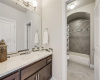 The bath offers a shared wet room, with a private vanity on each side.