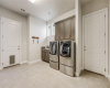 Laundry will be a breeze with this spacious room, complete with storage cabinets and a laundry sink.