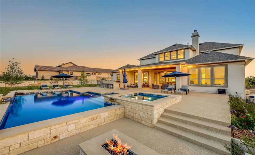 The backyard of your dreams awaits summer days in the pool, and cool fall nights surrounding the fire pit!