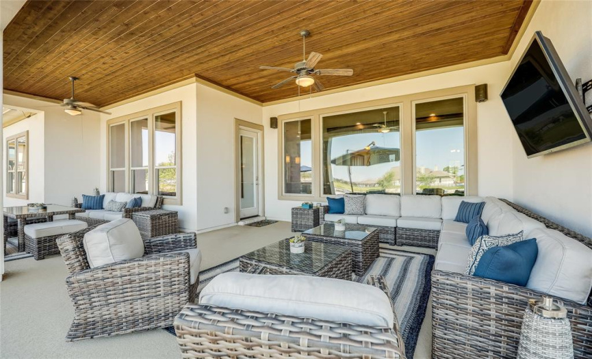 The spacious covered patio welcomes you to the backyard, offering numerous spaces for lounging and al fresco dining.