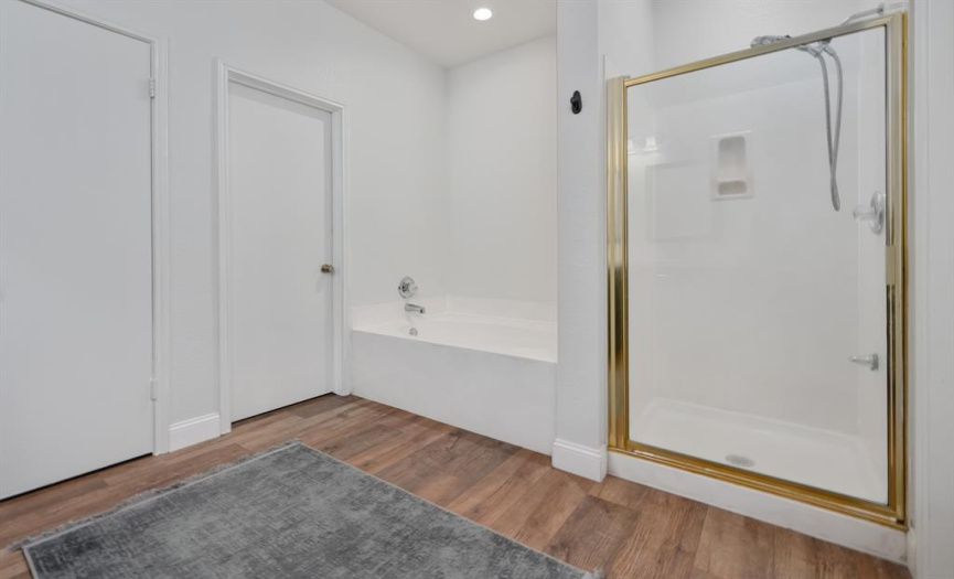 Inviting master bath with tub and large separate walk in shower 