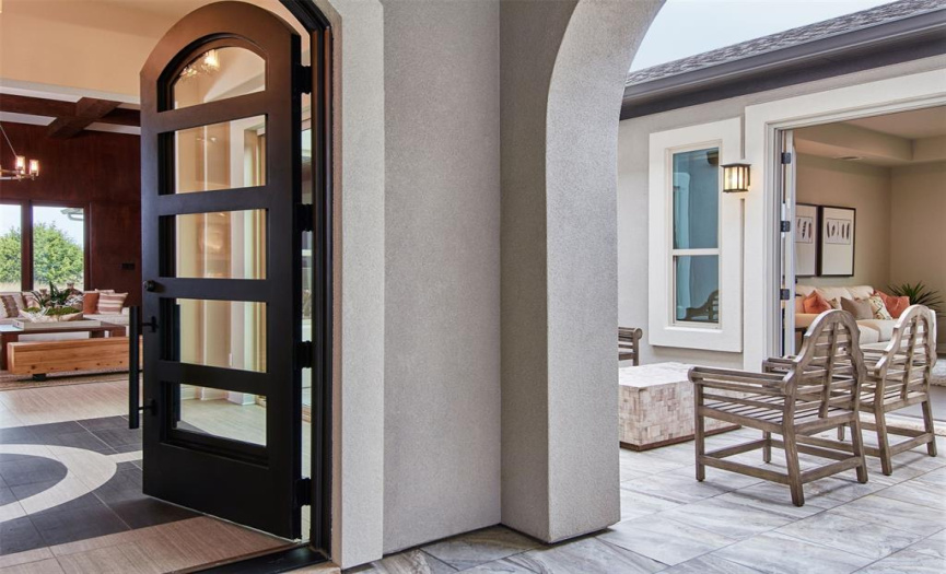 Custom arched steel main entry door. Attached in-law suite, offering a private entrance and courtyard.