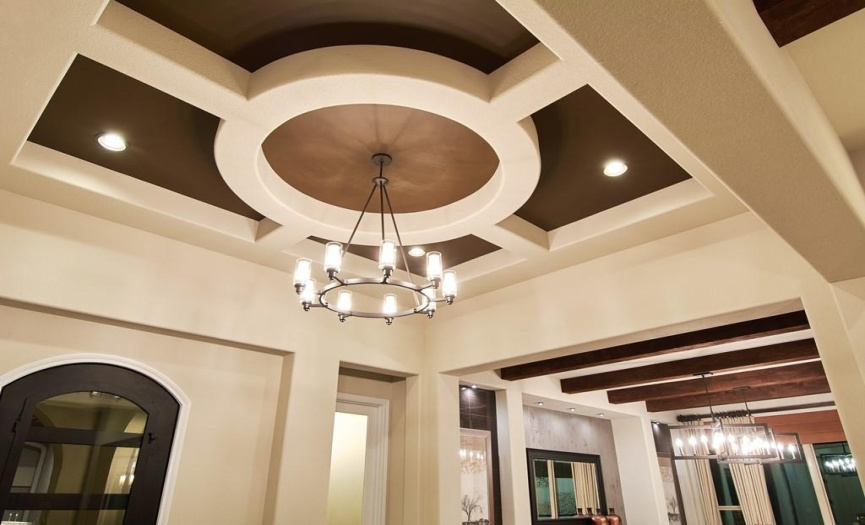 High ceilings throughout with custom beam work, tray ceilings, and specialty ceiling treatments.