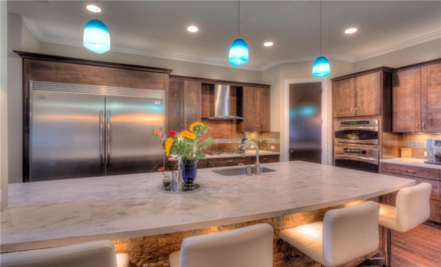 customized Corian countertops with over-sized sail-shaped island and single bowl stainless sink 