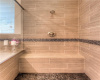 upgraded larger shower with dual shower heads, mud-set floor tile