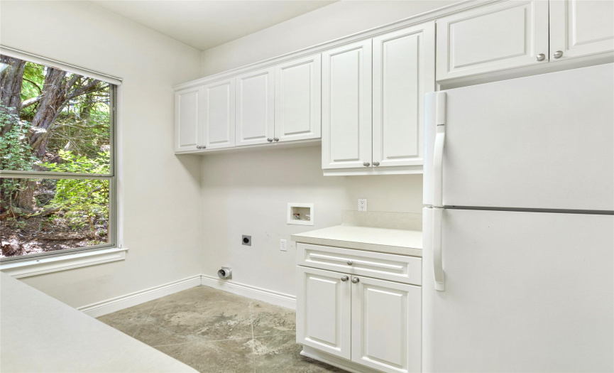 Now, this is a true laundry room with two sides of counter space, and upper and lower cabinetry, plus room for a full sized refrigerator. 