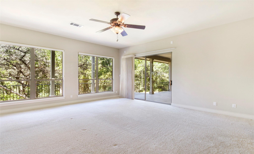 Spacious and private main level bedroom overlooks the scenic backyard.