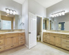 Double vanities with ample storage in the custom cabinetry