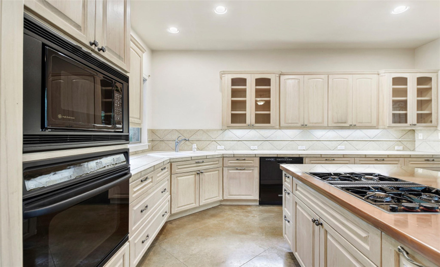 Custom designed kitchen is light, bright and includes breakfast dining and counter height seating space. 