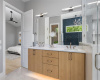 The glowing white oak vanity and extra storage make this primary bath both gorgeous and functional.