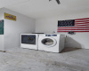 Washer and dryer (electric hook up) are located in the garage.  Plenty of room to add a refrigerator, also. 