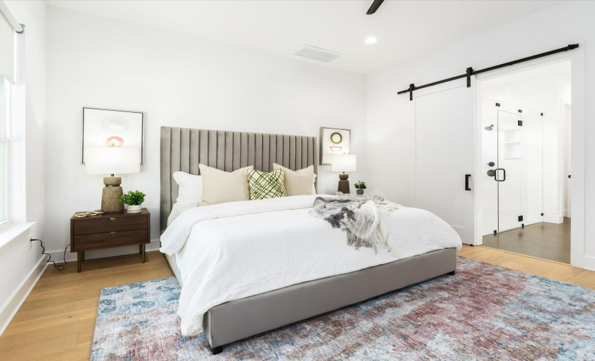 The spacious primary bedroom welcomes you with soft, muted tones, creating a serene ambiance that encourages restful nights and rejuvenating mornings