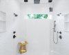You haven't experienced a shower like this one, with multiple shower heads, custom tile and a frameless glass enclosure 