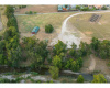 Aerial view of lot and embankment and Brushy Creek
