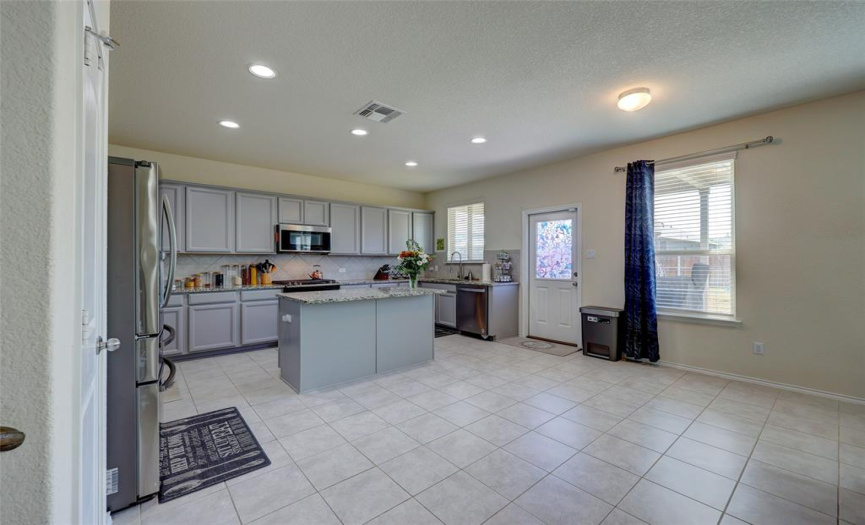 Pantry to the left, covered patio off the door to the backyard, plus room for a breakfast table- or a couple of stools at the center island for grab n go breakfasts.608 Reinhardt Blvd, Georgetown TX 78626. MLS #1500692.