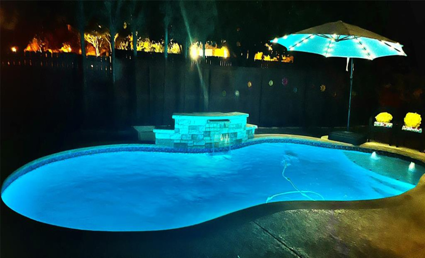 LED pool lights can change colors and are remote controlled.  So is the waterfall