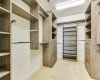 Primary walk in closet with custom built ins 