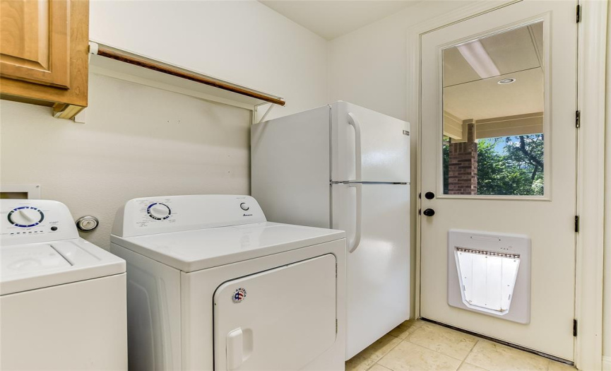 Main floor laundry room comes with washer/dryer & extra refrigerator