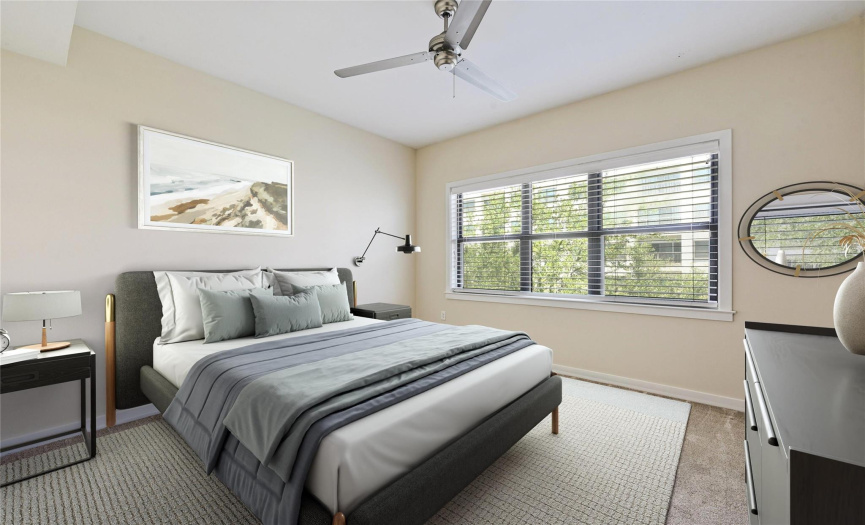 *Virtually Staged* The second bedroom offers a comfortable and inviting space, just like the master bedroom. Enjoy the cooling breeze from the ceiling fan and bask in the natural light streaming through the windows.