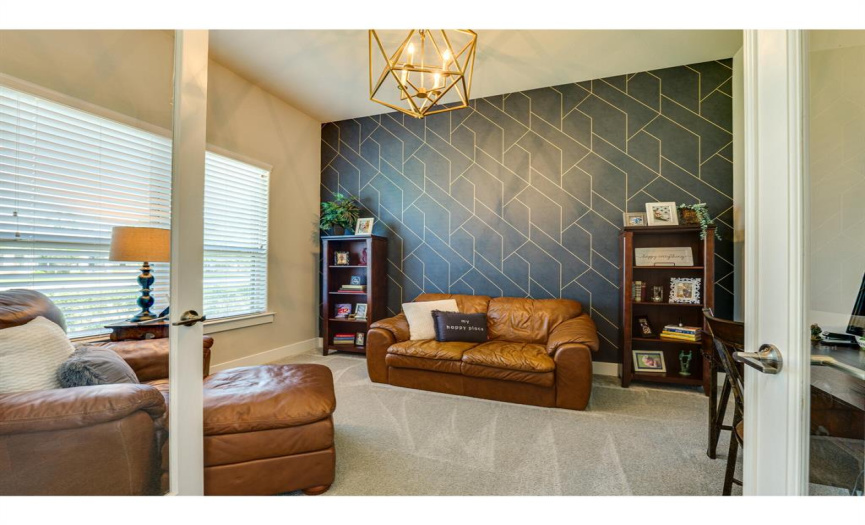 True study with glass French doors and wallpaper accent wall!