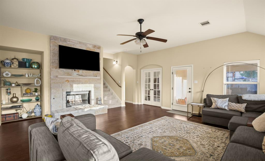 Unwind in the spacious living room that features high ceilings, a ceiling fan, and a great amount of natural light.