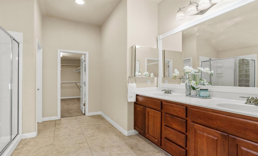 The opulent ensuite bath includes a dual vanity, luxurious soaking tub, separate shower, and a generous walk-in closet