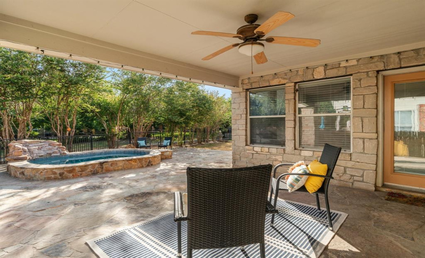 With the gentle breeze rustling through the leaves and the dappled sunlight filtering through the trees, the covered back patio is the perfect spot to unwind and bask in the natural beauty that surrounds you