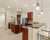 A chef's dream kitchen awaits with an incredible amount of storage, granite countertops, and built-in SS appliances, complimented by a large breakfast bar for casual dining
