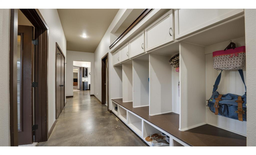 The mud area offers a smart and efficient solution to keep your essentials in order. Featuring a bench to sit and put on or take off shoes, as well as cabinets and hooks to hold belongings, this space is designed to simplify your daily routines