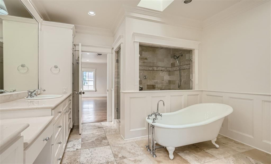 Large walk in shower and claw foot tub located in the primary bathroom