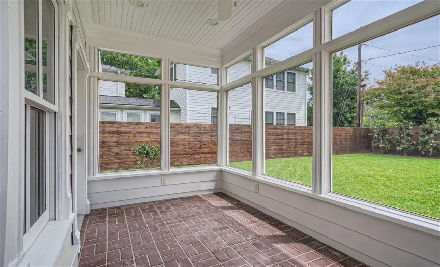This fantastic screened porch is located just off of the kitchen, and overlooking the nice, flat backyard