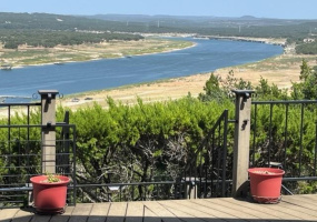 View of Lake Travis and the Texas Hill Country from the front porch of this home. When the lake is at its normal level, the entire brown section of dirt on the right side of the picture is underwater!