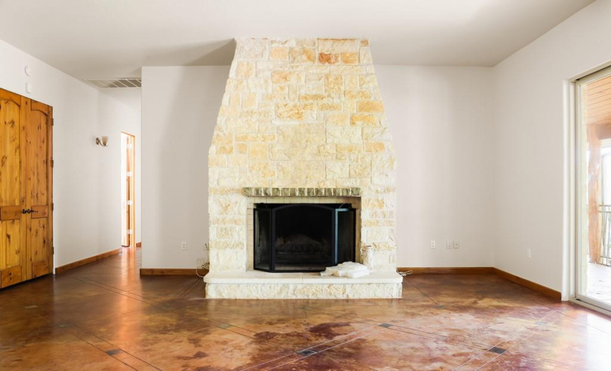 View from the kitchen onto the wood burning fireplace comprised of locally sourced limestone.