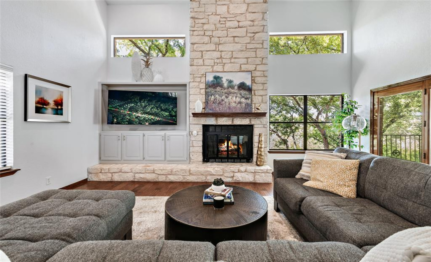 Dramatic stone firepace extends to the ceiling