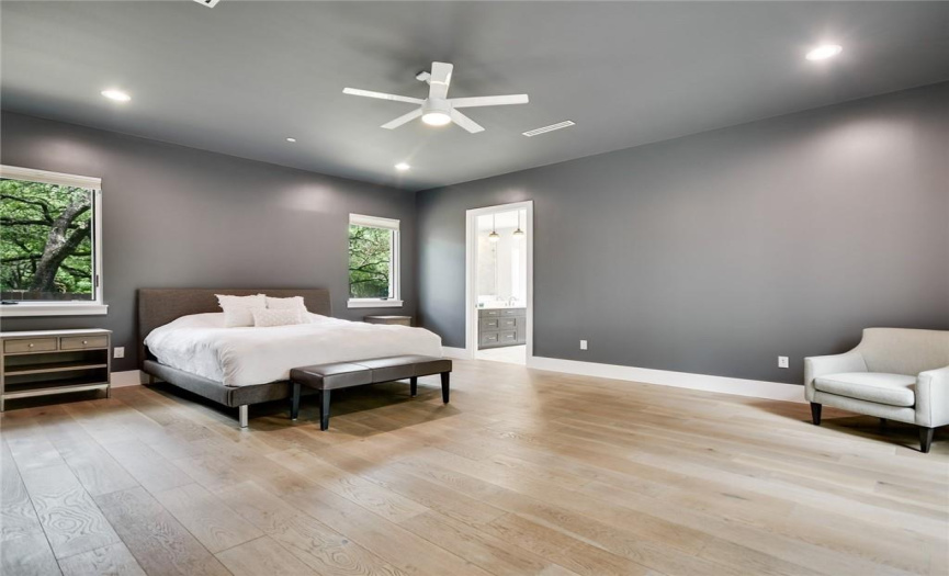 Spacious primary bedroom is on the main level with sliding glass door to backyard deck and adjoining spa-like bath & walk-in closet with brand new custom closet system. 