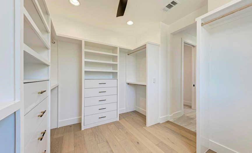 Primary closet with excellent storage for ease of organization