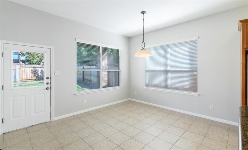 Breakfast area has a ceiling light, two-inch blinds, tile flooring, and measures approximately 12 x 13.