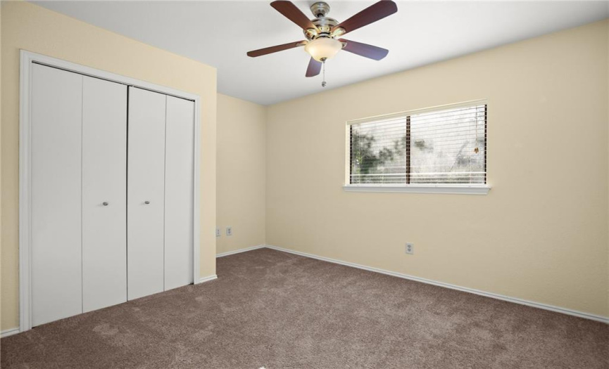 The third bedroom is also a generous size with carpet flooring and a ceiling fan.