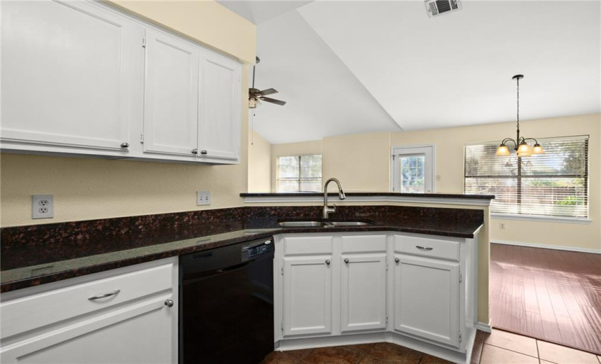 The kitchen is equipped with quality stainless-steel appliances including a freestanding gas range.