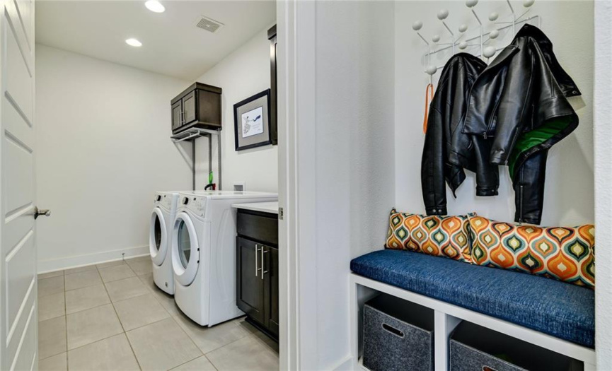 Spacious laundry room with separate area for coats and shoes.