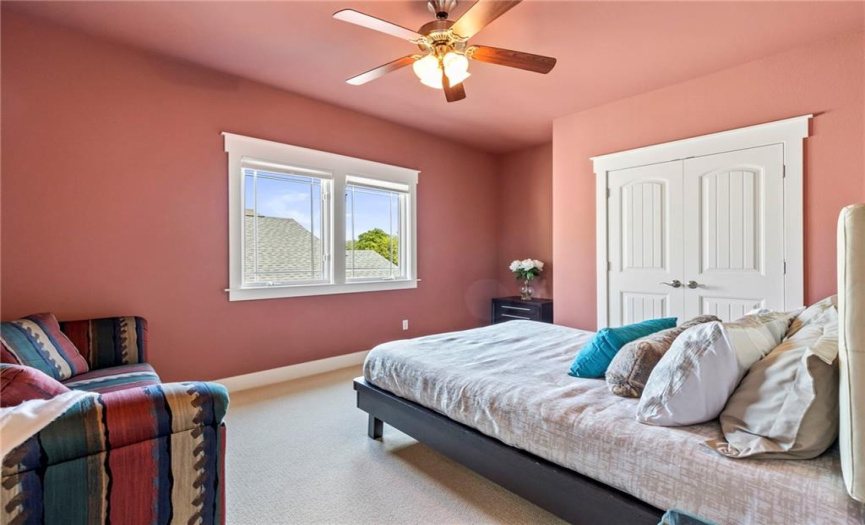 The third bedroom also offers carpet flooring, a ceiling fan, and a generously sized closet.