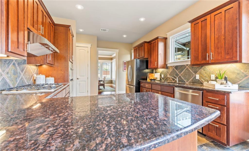 The kitchen offers an abundance of cabinetry for storage and counter space for preparing meals.