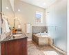 The primary bathroom is luxurious and features a double granite-topped vanity, undermount sinks, an oversized walk-in shower with a bench seat, and a large soaking tub where you can relax with a glass of wine.