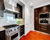 Stainless steel appliances include a gas range, range hood, dishwasher and built-in microwave