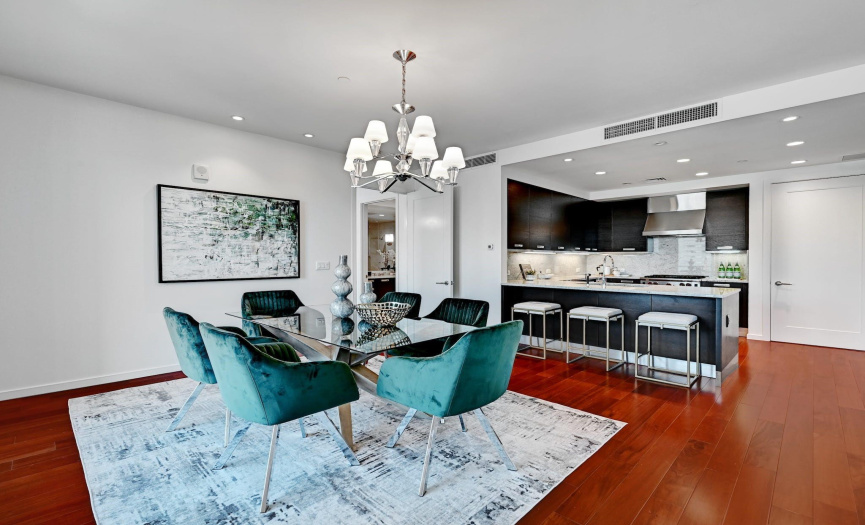 The open concept dining and kitchen space showcases a harmonious blend of design and functionality, offering a modern backdrop for shared meals and culinary creativity