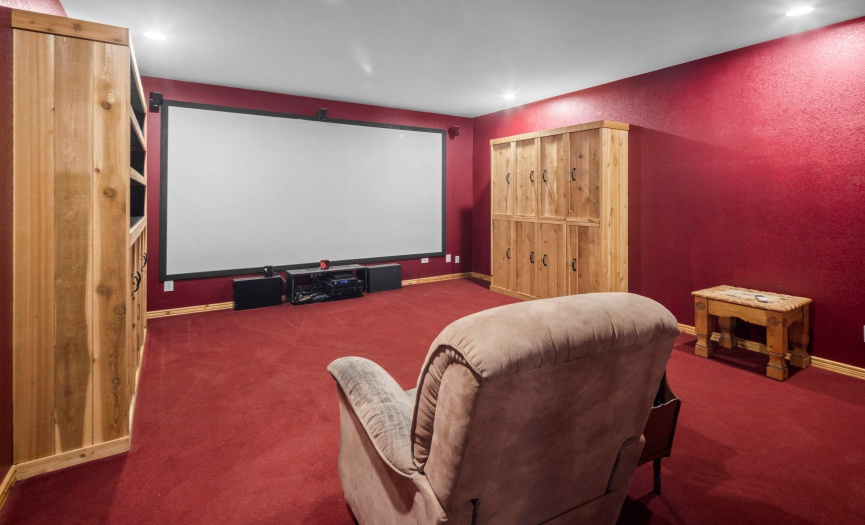 Media room with built-in storage and Murphy beds.