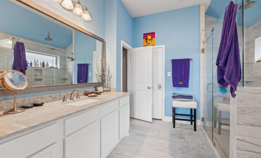 This spa-like ensuite bathroom features separate vanities, a luxurious oversized walk-in shower, private commode, and a walk-in closet. You'll love all the space on the principal vanity! 